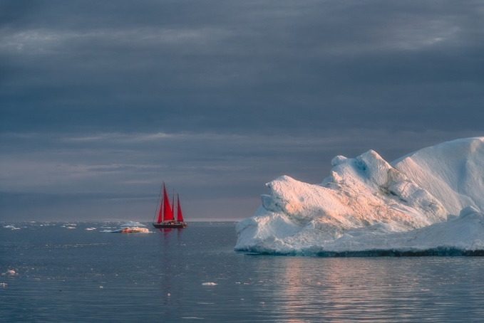 Red sails under cloud